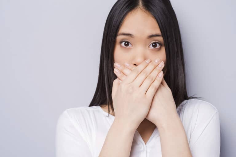 woman-covering-mouth