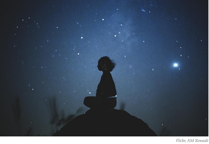 Woman contemplates under the stars