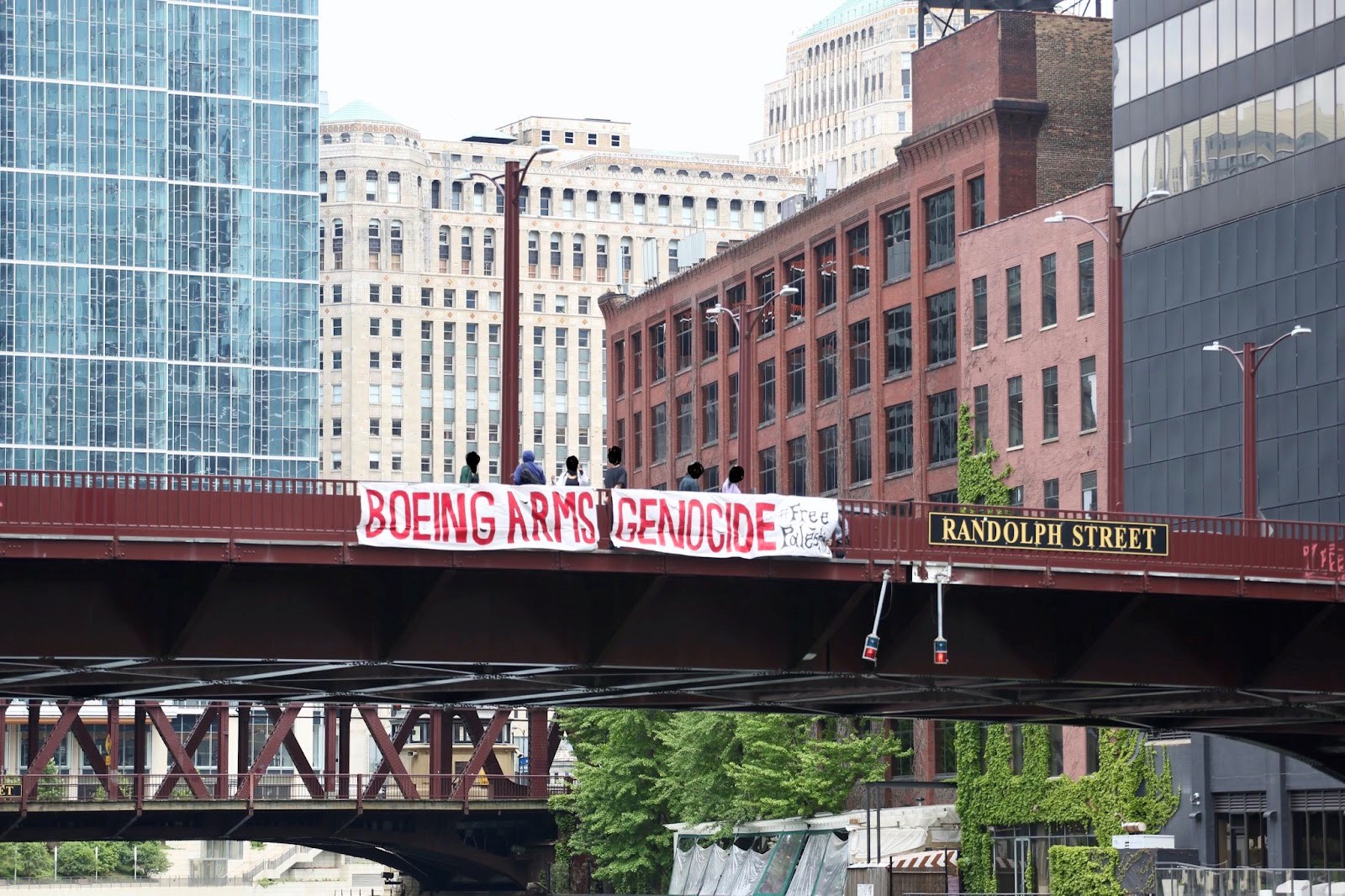 Boeing Arms Genocide protest sign over Randolph Street bridge in Chicago