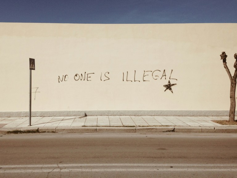 No one is illegal written on a wall