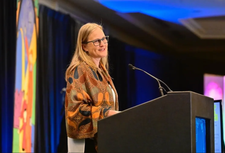 Dr. Ann Garrick speaking onstage