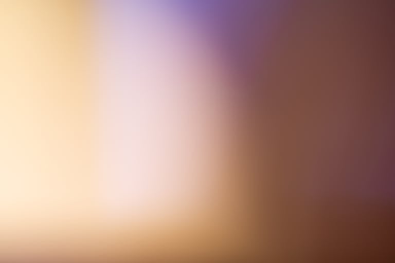 A soothing abstract blurred gradient background with warm tones.