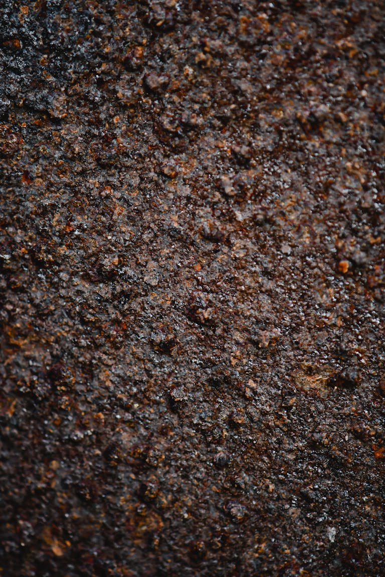Detailed close-up of a textured and rough rusty surface, ideal for backgrounds.